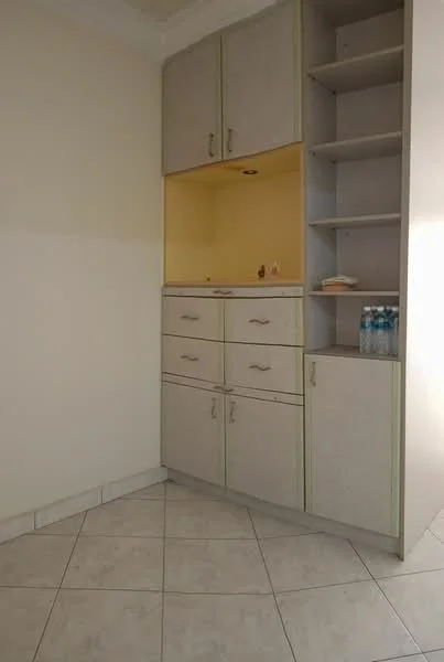 Room features: cream painted walls, light-colored cabinetry, built-in shelves, drawers with handles, countertop space, tile flooring, corner layout, recessed lighting; style: modern.
