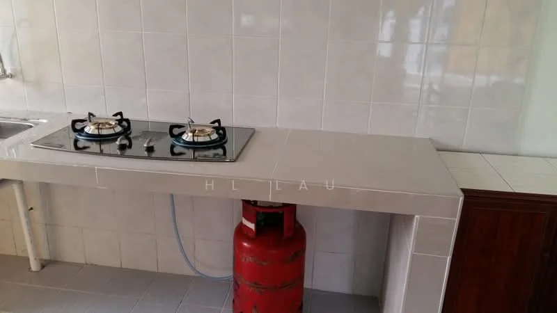Kitchen features: gas stove with two burners, grey countertop, white tiled backsplash, white tiled walls, grey tile flooring, red gas cylinder, built-in cabinetry, sink with faucet.