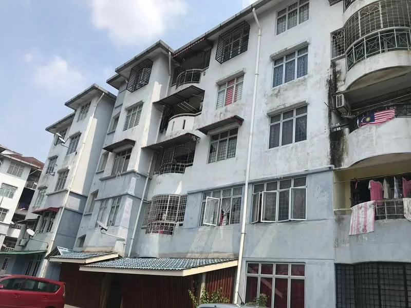 Exterior type: low-rise apartment block; features: white painted facade, balconies with metal railings, multiple storeys, visible air conditioning units, laundry hanging on balconies, roof overhang, ground-level parking area, windows with grilles; style: modern.