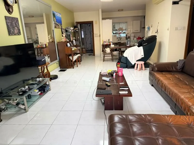 Living features: brown leather sofa, wood coffee table, flat-screen TV on stand, glass TV console, white tiled flooring, wall-mounted mirror, green accent wall, recessed lighting, dining table in background, kitchen area visible, decorative wall art; style: contemporary.
