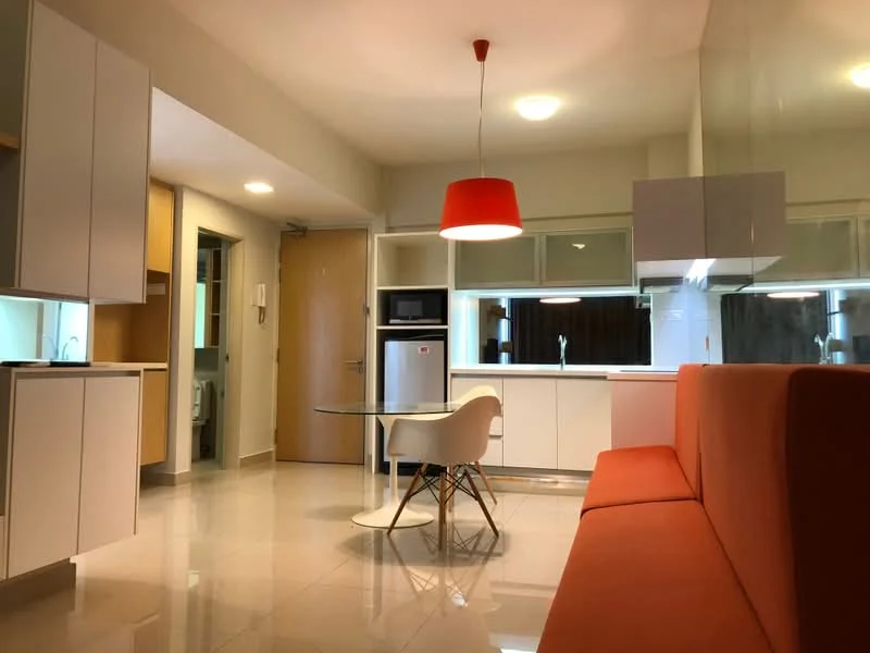 Living features: orange fabric sofa, glass dining table, white plastic dining chairs, white cabinetry, stainless-steel fridge, built-in microwave, recessed ceiling lights, pendant light fixture in red, polished tile flooring, open layout, large windows, kitchenette area; style: modern.