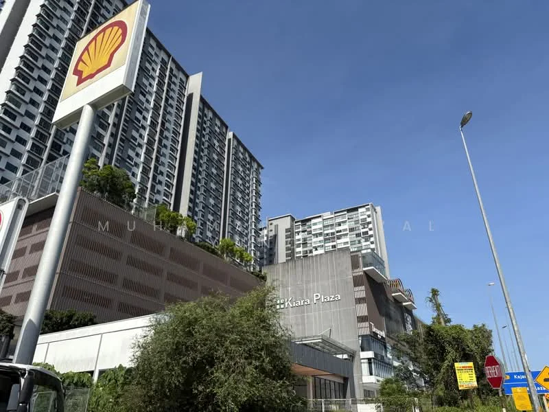 Exterior type: mixed-use development; features: high-rise condominium, commercial plaza, glass facade, signage for Shell, surrounding greenery, street view, parking area, urban context; style: modern.