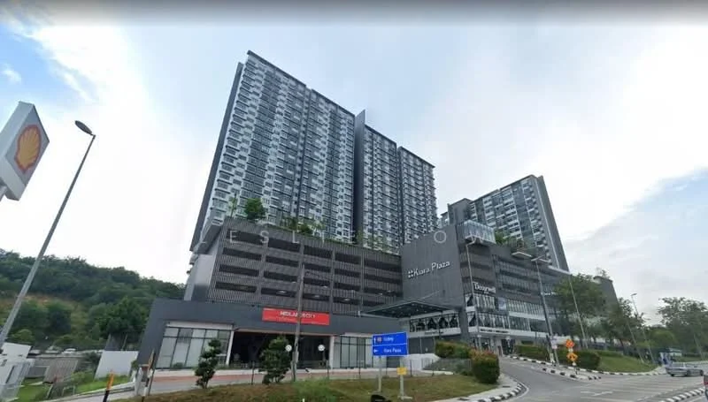 Exterior type: high-rise condominium; features: glass curtain wall, grey concrete facade, multiple balconies, landscaped garden area, parking deck, signage at entrance, surrounded by greenery, driveway with interlocking pavers; style: modern.