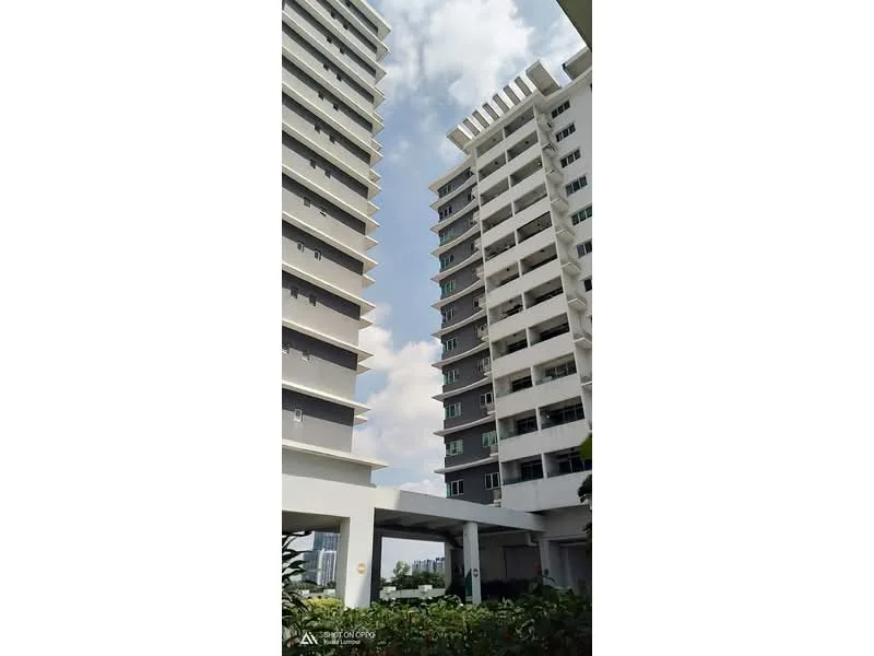 Exterior type: high-rise condominium; features: white painted facade, glass windows, balconies on upper floors, multiple storeys, covered parking area, surrounded by greenery; style: modern.