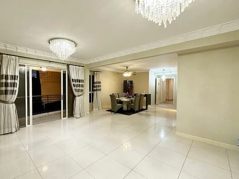 Living features: large floor-to-ceiling windows, sliding glass door, cream painted walls, white ceiling with crown moulding, chandelier with crystals, 2-blade ceiling fan, white tiled flooring, dining table with 6 chairs, decorative wall art, sheer curtains with striped pattern, area rug, indirect lighting; style: modern; view: city.
