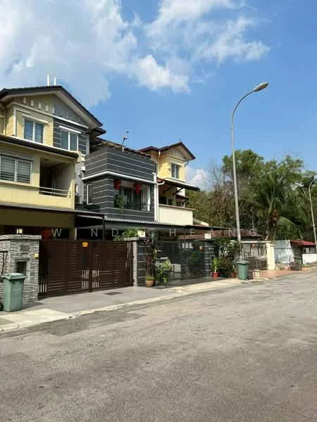 Exterior type: linked terrace house; features: two-storey building, grey and yellow painted facade, stone cladding at the base, recessed balconies, gated entrance, manicured landscaping, palm trees, street lighting, driveway with interlocking pavers, surrounded by residential area; style: modern.