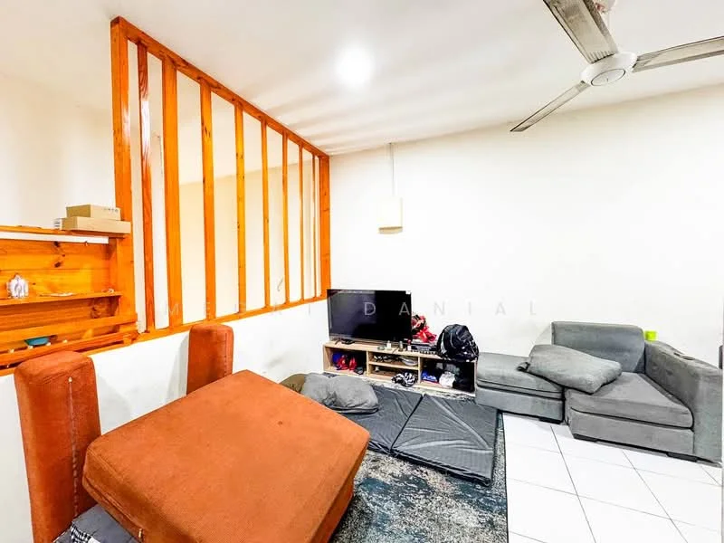 Living features: grey fabric sectional sofa, brown upholstered ottoman, black TV console, wall-mounted TV, white tiled flooring, wooden partition wall, ceiling fan, decorative shelving unit, area rug with geometric pattern; style: modern.