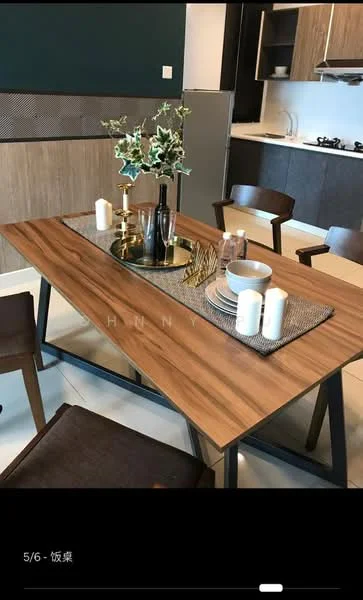 Dining features: wooden dining table with metal legs, four wooden dining chairs, decorative centerpiece with candles, table runner, white dinner plates, glass vase with greenery, cutlery set, neutral wall color, open kitchen view in background, modern cabinetry, stainless-steel gas stove, white countertops; style: modern.