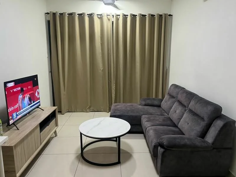 Living features: grey fabric sectional sofa, round black coffee table, wooden TV console, wall-mounted TV, cream painted walls, light-colored tile flooring, curtains in beige, recessed ceiling light; style: modern.