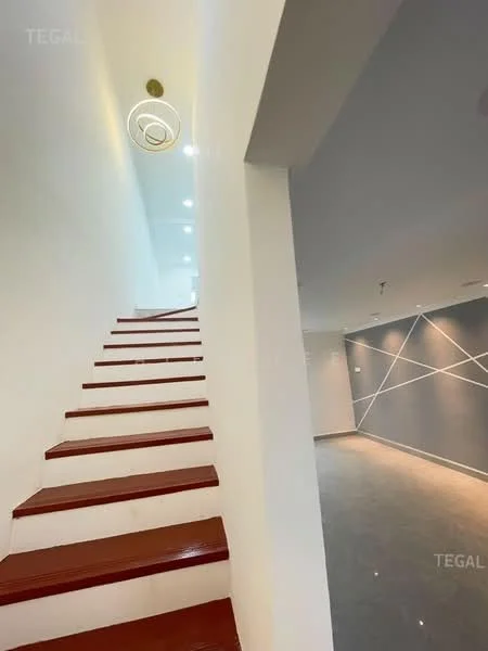 Room features: staircase with wooden steps, white painted walls, recessed lighting, modern pendant light fixture, grey tiled flooring, geometric wall design, open space layout; style: modern.