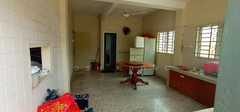 Room features: ceiling fan, round dining table, white walls, tile flooring, window with metal grille, built-in cabinetry, freestanding fridge, sink, laundry basket, red plastic bags, cleaning supplies, open layout.