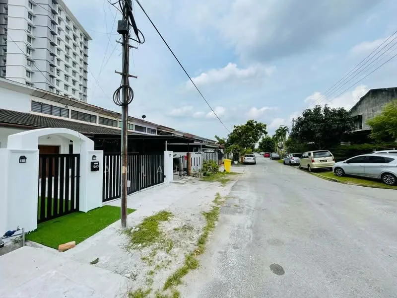 Exterior type: linked terrace house; features: white painted facade, black metal gate, manicured lawn, paved walkway, surrounded by greenery, single-storey, adjacent to road, street view with parked cars; style: modern.