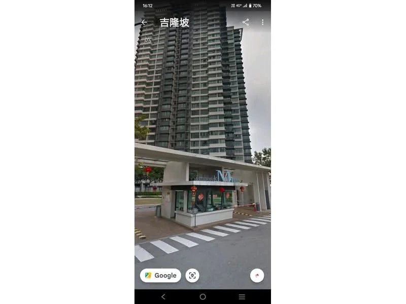 Exterior type: high-rise condominium; features: glass curtain wall, projecting balconies, double-volume main lobby, guard house at entrance, surrounded by mature greenery, fronts a main road; style: modern.
