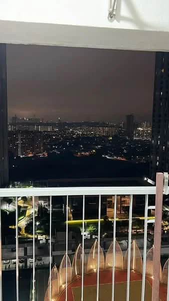 Room features: balcony with railing, city skyline view, nighttime lighting, floor-to-ceiling windows; style: modern; view: city.