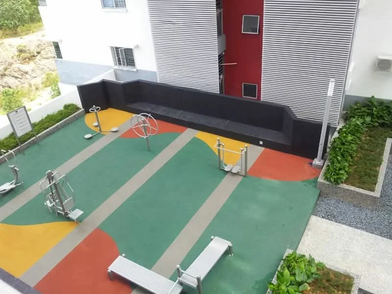 Exterior type: landscape garden; features: outdoor gym equipment, colorful rubberized flooring, benches, landscaped garden area, gravel pathway, exercise stations, greenery along the edges; style: modern.