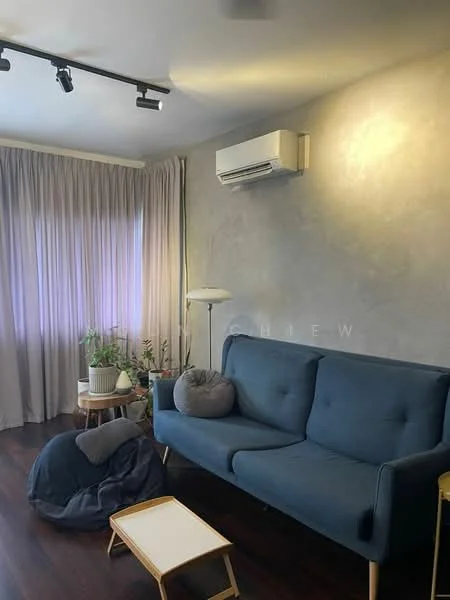 Living features: blue fabric sofa, floor lamp, small coffee table, bean bag chair, potted plants, grey accent wall, dark wood flooring, wall-mounted split AC, curtains, track lighting; style: modern.