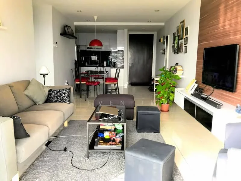 Living features: grey fabric 3-seater sofa, black coffee table, area rug with geometric pattern, wall-mounted TV, entertainment unit, decorative plants in pots, black ottomans, floor-to-ceiling windows, recessed downlights, light fixture with red shade; style: modern. Kitchen features: black cabinetry, stainless-steel appliances, open-plan layout, dining table with black chairs, grey backsplash, kitchen island, refrigerator, built-in oven; style: modern.
