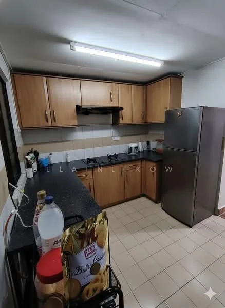 Kitchen features: brown wooden cabinetry, black granite countertop, stainless-steel fridge, built-in gas hob, exhaust hood, white tiled backsplash, cream tiled flooring, single-bowl stainless-steel sink, wall-mounted shelves, window with black frame, light fixture on ceiling, kitchen utensils on countertop, water bottle on countertop; style: modern.