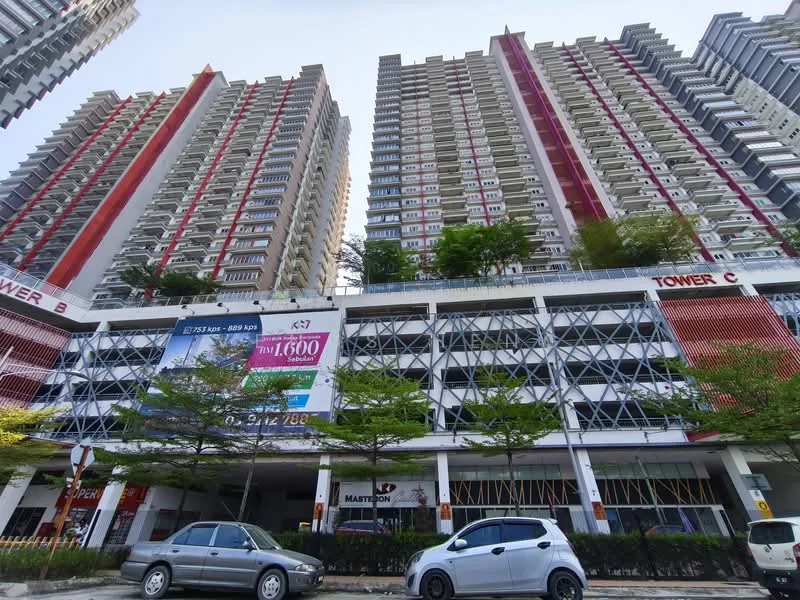 Exterior type: high-rise condominium; features: red and white painted facade, glass curtain wall, multiple storeys, balconies on upper floors, parking deck visible, landscaped greenery at ground level, signage for commercial units, surrounded by trees; style: modern.