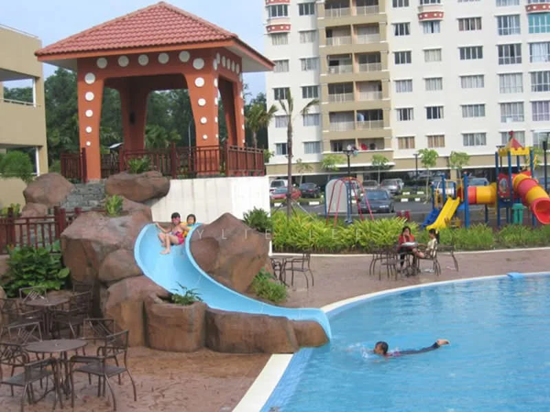Exterior type: swimming pool deck; features: swimming pool with slide, rock formation around pool, children's playground in background, outdoor seating with tables and chairs, covered gazebo with decorative pillars, landscaped garden area, playground equipment including slides and swings, paved pool deck, lawn area surrounding pool, residential building in background; style: tropical-modern.