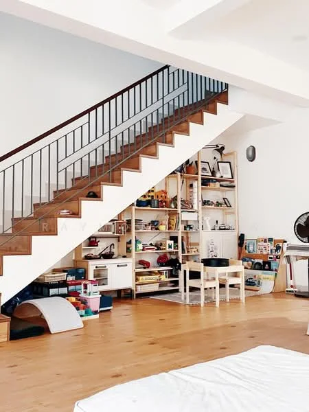 Room features: wooden flooring, white painted walls, open shelving unit with various items, staircase with wooden steps and metal railing, children's toys and storage bins, small table and chairs, decorative items on shelves, ceiling light fixture; style: modern.