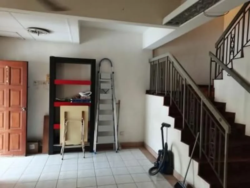 Room features: white painted walls, tile flooring, staircase with metal railing, wooden door, ladder, vacuum cleaner, shelving unit, open space layout.