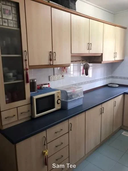 Kitchen features: light wood cabinetry, blue laminate countertop, microwave, glass-front upper cabinets, multiple drawers, tile backsplash, white tiled walls, blue tiled flooring.