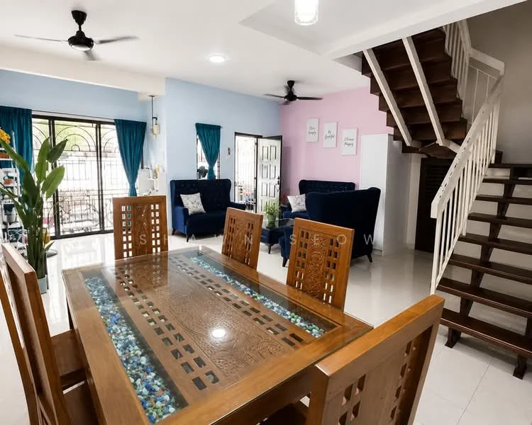 Dining features: wooden dining table with glass top, 8 wooden dining chairs, decorative pebbles in table center, white walls, recessed ceiling lights, 2 ceiling fans, tile flooring, open layout to living area; style: modern. Living features: 2 blue fabric sofas, coffee table, decorative plants, white walls, blue accent wall, curtains, tile flooring; style: modern. Staircase features: wooden staircase, white railing, open design; style: modern.