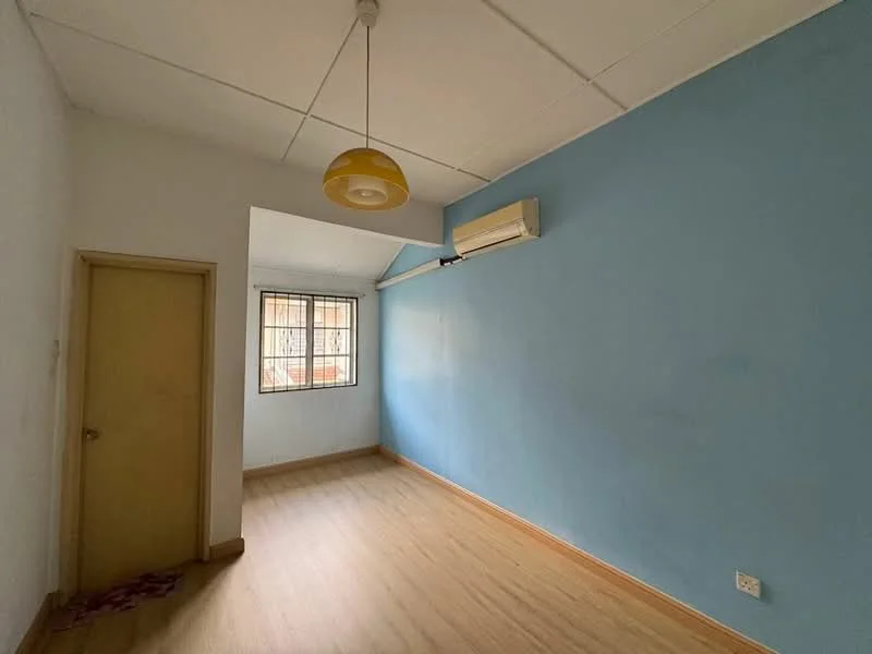 Room features: light blue painted walls, white ceiling, laminate flooring, 1 wall-mounted split AC, single door, window with metal grille, hanging pendant light, baseboard trim; style: minimalist.