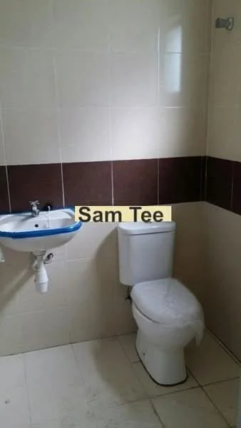 Bathroom features: white ceramic toilet, single-sink vanity with white basin, chrome faucet, brown tiled accent wall, cream tiled walls, white tiled flooring, natural light from window.