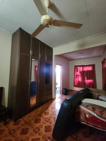 Bedroom features: wooden wardrobe with mirrored doors, queen-size bed with upholstered headboard, ceiling fan with light, red curtains, tiled flooring with geometric pattern, wall with light paint, doorway leading to another room, chair.