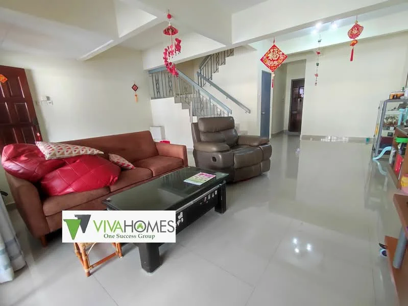 Living features: grey tiled flooring, white painted walls, sofa in brown leather, red accent cushions, coffee table with black surface, decorative wall hangings, staircase leading to upper floor, ceiling with decorative lanterns, open layout, natural light from windows; style: modern.