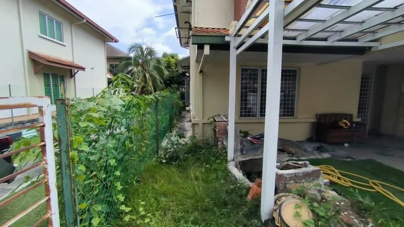 Exterior type: semi-detached house; features: green fence, paved walkway, garden area, exposed brick wall, covered porch, adjacent house visible, tropical landscaping, outdoor seating area; style: modern.
