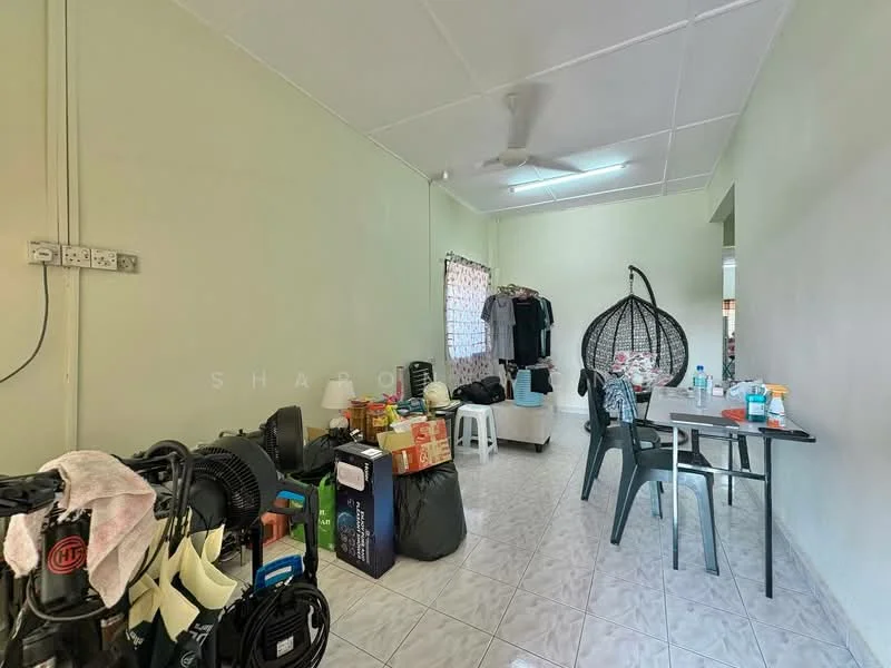 Room features: light green painted walls, white ceiling, ceramic tile flooring, ceiling fan, hanging rattan chair, plastic dining table with chairs, various boxes and bags, window with sheer curtains, multiple electrical outlets, cluttered space; style: minimalist.