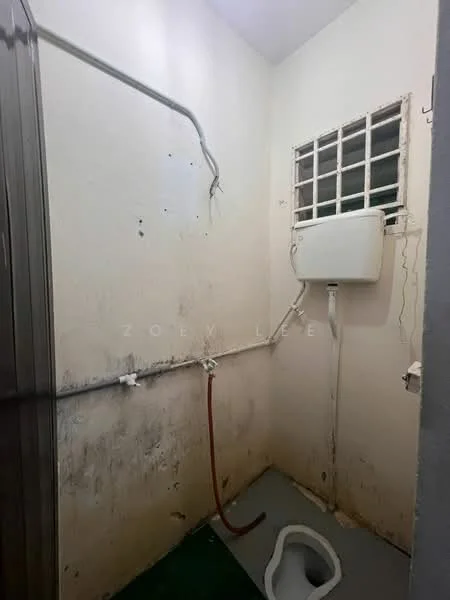 Laundry features: exposed plumbing, wall-mounted water heater, window with metal grille, concrete flooring, dirty walls, toilet bowl, hose connection.