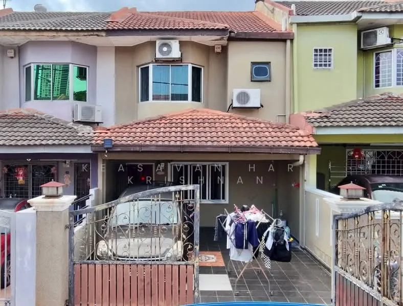 Exterior type: linked terrace house; features: two-storey building, red tiled roof, cream painted facade, green painted facade, air conditioning units visible, front porch area, decorative wrought iron gate, paved driveway, laundry drying area, front garden area; style: modern.
