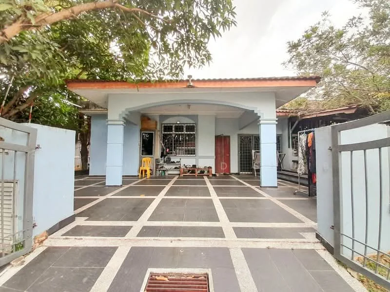 Exterior type: detached bungalow; features: blue painted facade, flat roof, single-storey, manicured lawn, paved walkway, metal gate, gravel driveway, surrounded by trees; style: modern.
