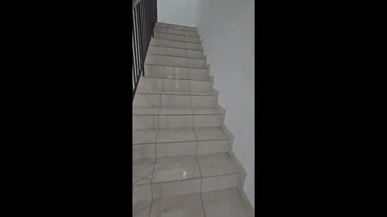 Room features: ceramic tile flooring, white painted walls, staircase with handrail.