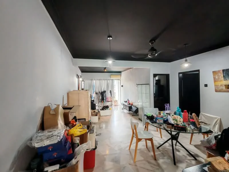 Room features: black painted ceiling, white painted walls, marble flooring, ceiling fan, 2 pendant lights, round dining table, wooden dining chairs, various boxes and items scattered, clothes hanging in the background, open space layout; style: modern.
