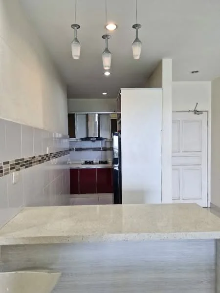 Kitchen features: granite countertop, white cabinetry, stainless-steel fridge, built-in oven, 4-burner gas hob, pendant lighting, tile backsplash, ceramic tile flooring, recessed downlights, open layout, kitchen island with seating, double-bowl stainless-steel sink; style: modern.