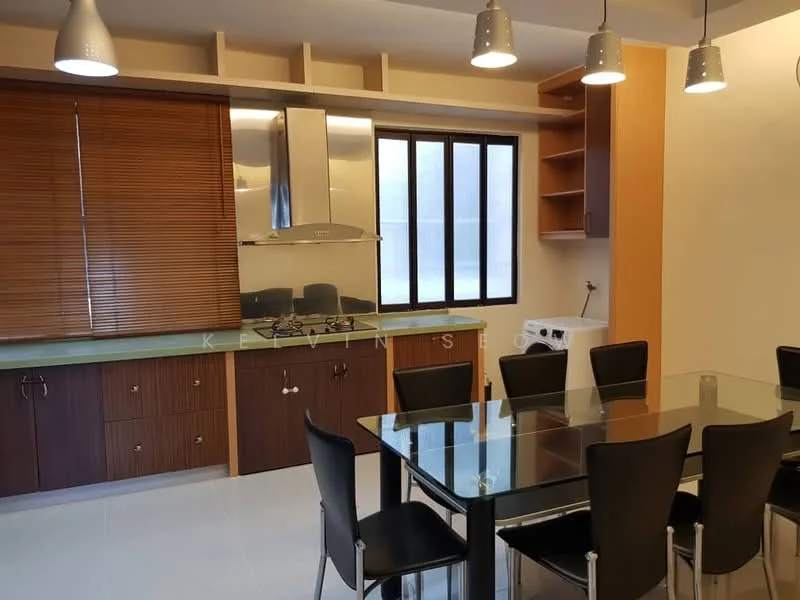 Kitchen features: brown wooden cabinetry, green countertop, stainless-steel range hood, built-in gas stove, double-bowl stainless-steel sink, black dining table with glass top, black dining chairs, window with wooden blinds, white washing machine, light grey tiled flooring, orange accent wall, shelving unit above countertop, recessed lighting; style: modern.