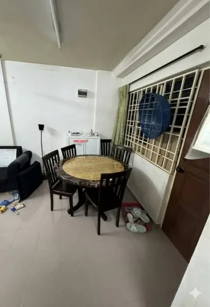 Dining features: round wooden dining table, 4 wooden dining chairs, light-colored tiled flooring, green curtains, wall-mounted air conditioning unit, window with metal grille, wooden door, floor lamp, slippers on the floor.