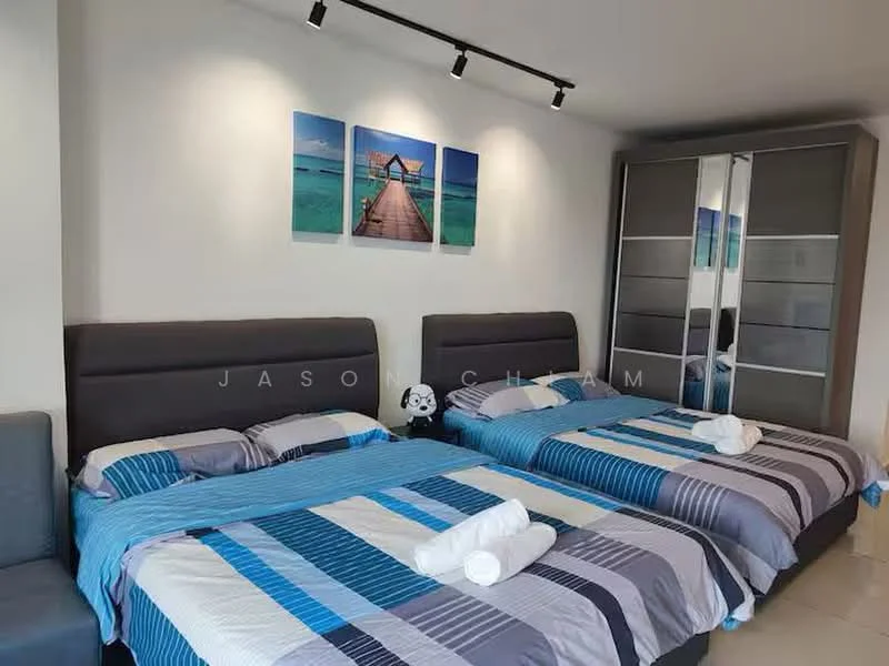 Bedroom features: two queen-size beds with grey upholstered headboards, striped bedding in blue and grey, two white towels rolled on the beds, grey fabric sofa, built-in wardrobe with sliding glass doors, wall-mounted artwork featuring a wooden walkway over water, recessed ceiling lights, tile flooring; style: modern.