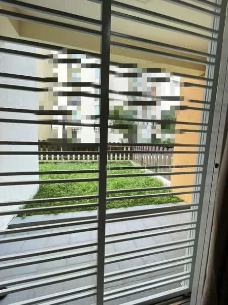 Room features: sliding glass door, horizontal metal window grills, green lawn, paved flooring, fenced area, exterior wall, outdoor view; view: garden.