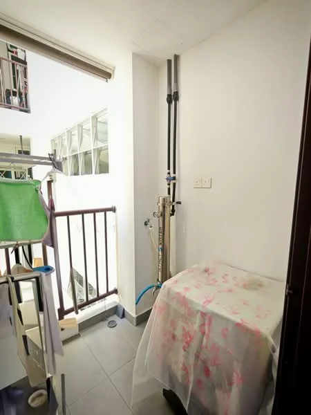 Laundry features: grey tiled flooring, white painted walls, washing machine connection, drainage outlet, clothes drying rack, balcony access, window for natural light, countertop with floral cover.