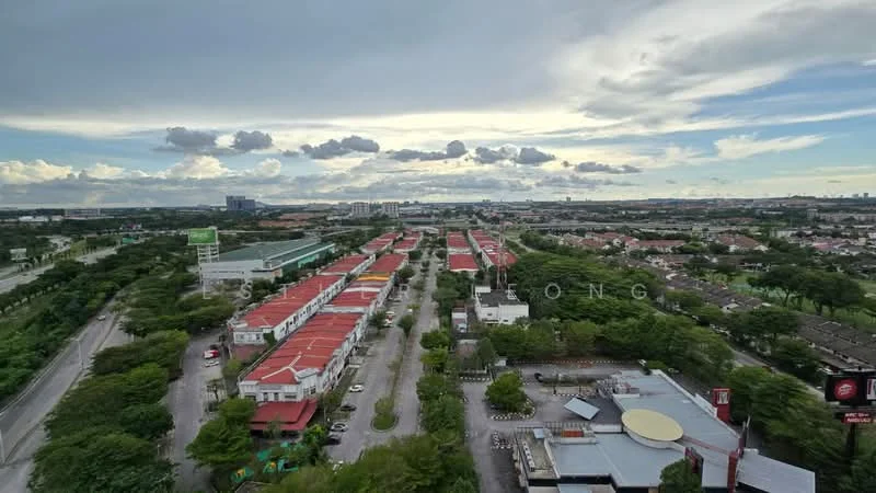 Exterior features: aerial view of residential area, rows of single-storey houses, green landscaping with trees, wide roads, commercial buildings visible in distance, cloudy sky, urban setting; style: modern.