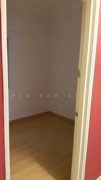 Room features: light wood flooring, white painted walls, red accent wall, window with no visible treatment, door frame, empty space.