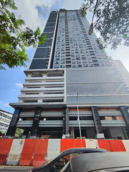 Exterior type: high-rise condominium; features: glass curtain wall, black and white facade, recessed balconies, approximately 20-storey high-rise, construction scaffolding visible, surrounded by construction barriers, street view, urban context; style: modern.