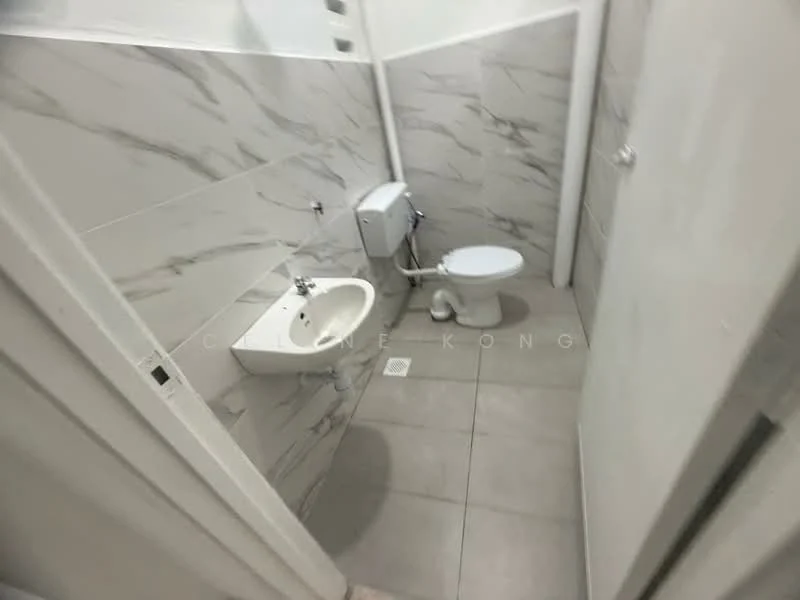 Bathroom features: white wall tiles with marble pattern, grey floor tiles, wall-mounted toilet, pedestal sink, chrome faucet, toilet roll holder, drainage grate in floor; style: modern.