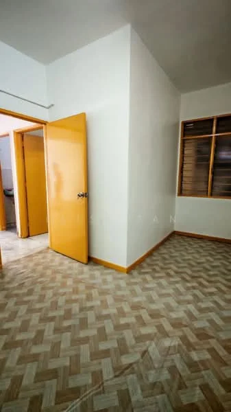 Room features: light yellow painted walls, wooden flooring with herringbone pattern, two wooden doors, window with wooden frame, neutral ceiling, baseboards, natural light from window.